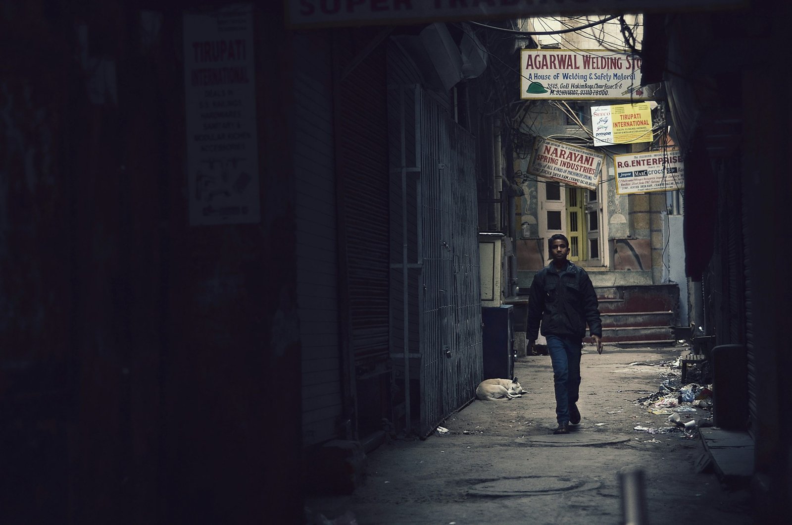 A child walks down a lane in an Indian town